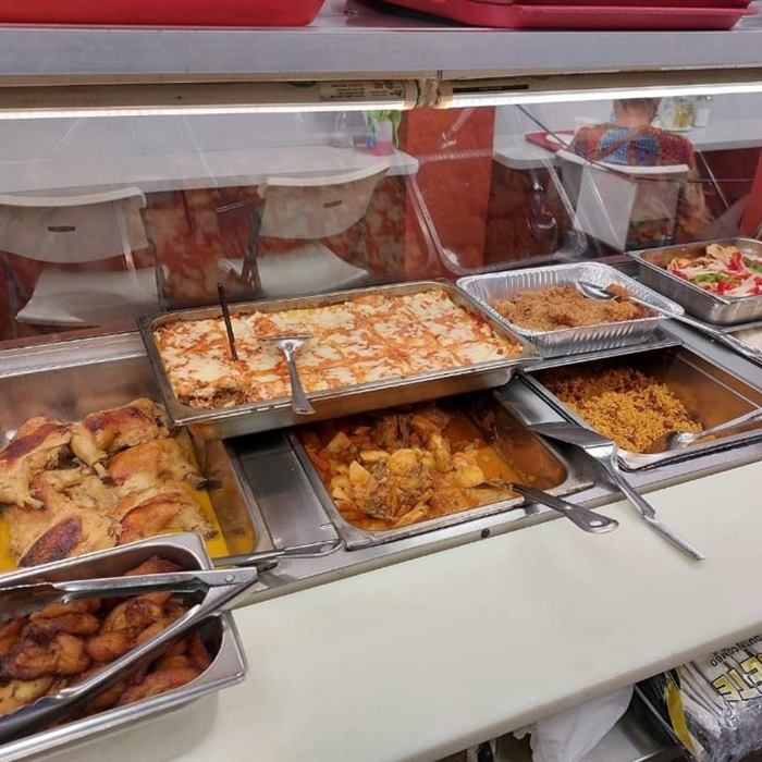 Bandejas calientes con lasaña, pollo asado, amarillos fritos, arroz blanco, arroz amarillo y pollo guisado
